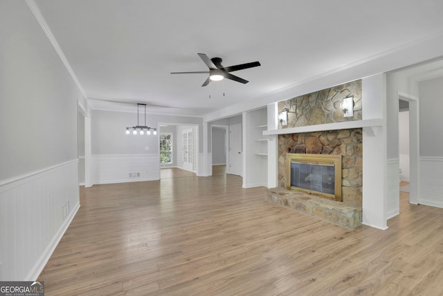4516 Creekwood Cir NW, Kennesaw, GA 30152 - unfurnished living room with a ceiling fan, light wood finished floors, a fireplace, ornamental molding, and built in features