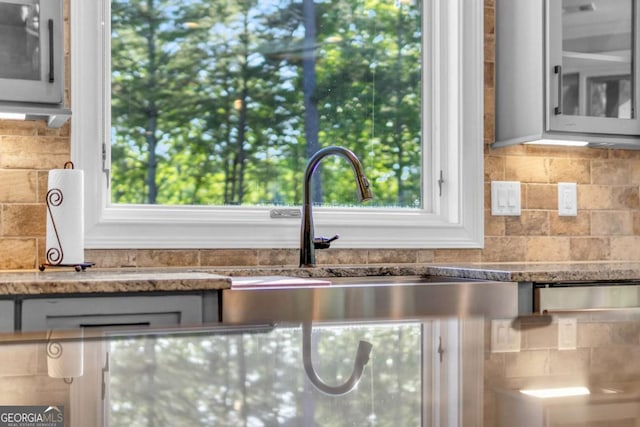 117 Valley View Ct, Blairsville, GA 30512 - kitchen with tasteful backsplash, glass insert cabinets, healthy amount of natural light, and light stone countertops