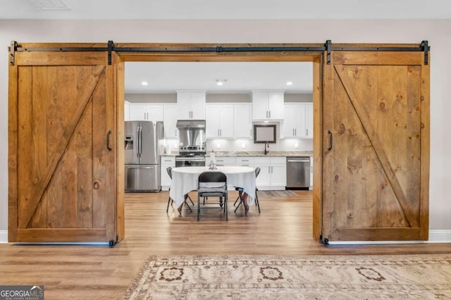 117 Valley View Ct, Blairsville, GA 30512 - kitchen with a barn door, appliances with stainless steel finishes, light wood finished floors, and recessed lighting