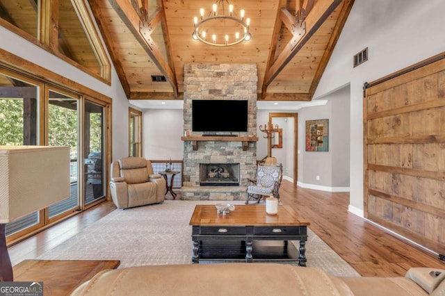 117 Valley View Ct, Blairsville, GA 30512 - living area with a wooden ceiling with exposed beams, wood finished floors, high vaulted ceiling, a fireplace, and a chandelier