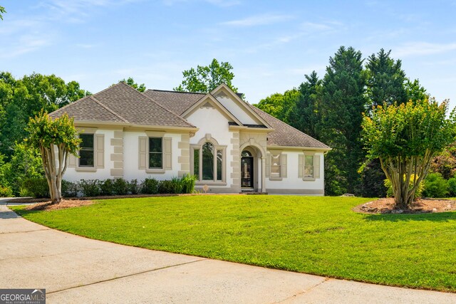 7025 Bavarian Wood Pl, Buford, GA 30518 - french provincial home with stucco siding, a front lawn, and roof with shingles
