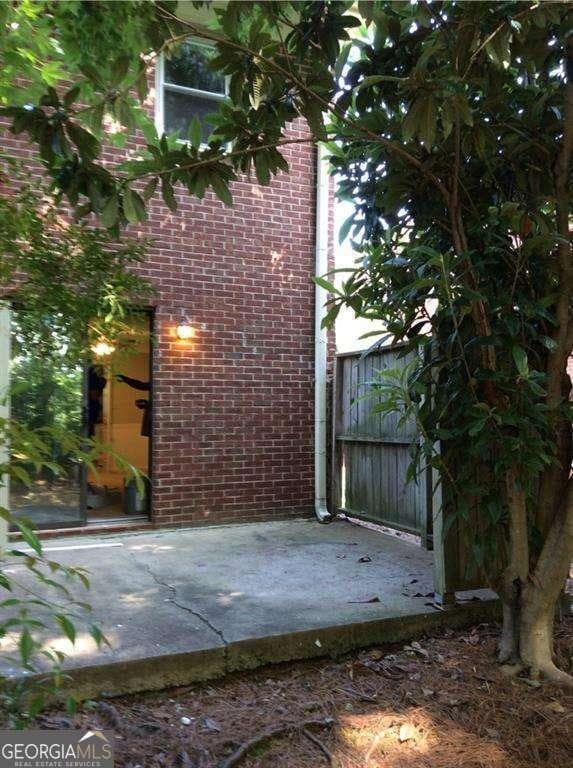 136STERLINGCO Sterling Ct, Alpharetta, GA 30004 - view of property exterior with brick siding and a patio