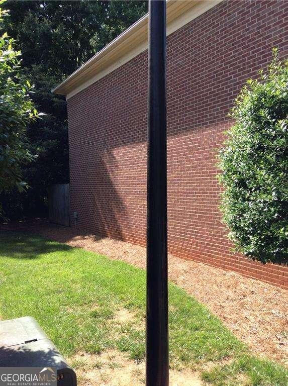 136STERLINGCO Sterling Ct, Alpharetta, GA 30004 - view of side of property with brick siding and a lawn