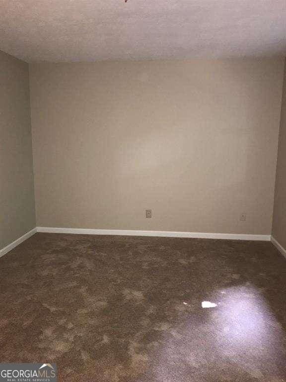 136STERLINGCO Sterling Ct, Alpharetta, GA 30004 - unfurnished room with baseboards, a textured ceiling, and dark carpet