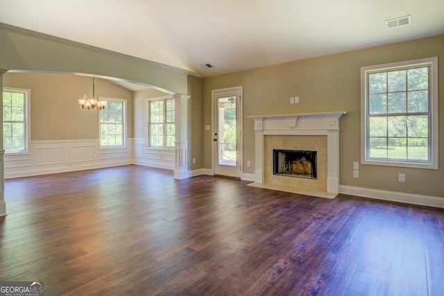 70 Country Meadows Ln, Covington, GA 30014 - unfurnished living room featuring a chandelier, healthy amount of natural light, dark wood-style flooring, a fireplace, and vaulted ceiling
