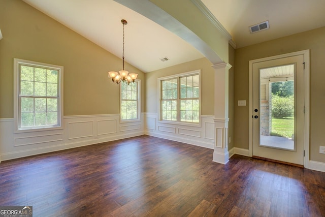 70 Country Meadows Ln, Covington, GA 30014 - unfurnished dining area featuring a wainscoted wall, dark wood-type flooring, a chandelier, arched walkways, and vaulted ceiling