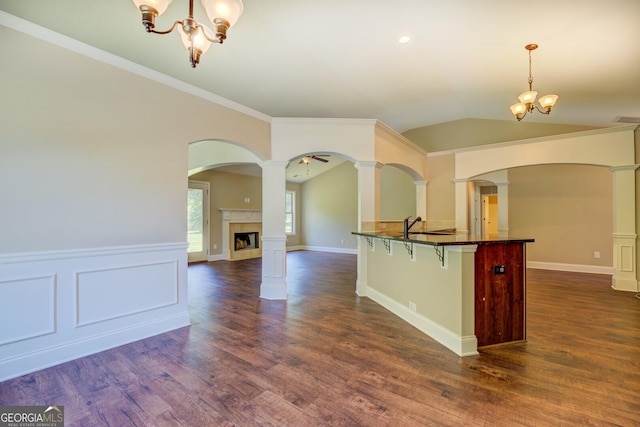 70 Country Meadows Ln, Covington, GA 30014 - kitchen with a chandelier, a kitchen breakfast bar, arched walkways, crown molding, and vaulted ceiling