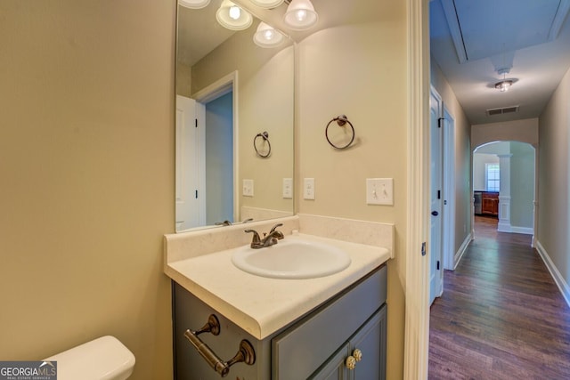 70 Country Meadows Ln, Covington, GA 30014 - bathroom with vanity, wood finished floors, decorative columns, and toilet