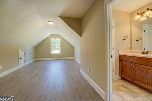 70 Country Meadows Ln, Covington, GA 30014 - additional living space featuring a sink, vaulted ceiling, light wood finished floors, and baseboards