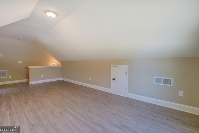 70 Country Meadows Ln, Covington, GA 30014 - bonus room featuring lofted ceiling, light wood-style floors, and baseboards