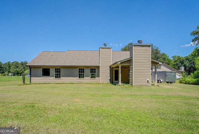 70 Country Meadows Ln, Covington, GA 30014 - rear view of house with a yard, a chimney, and a shingled roof