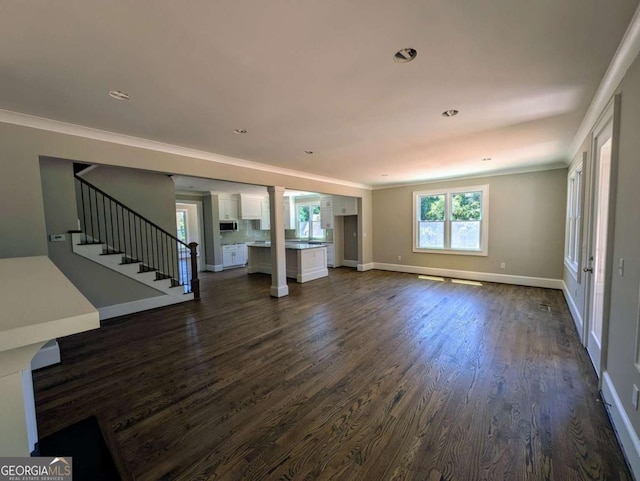 8239 High Lake Ter, Covington, GA 30014 - unfurnished living room featuring dark wood-style floors, stairway, ornamental molding, baseboards, and recessed lighting