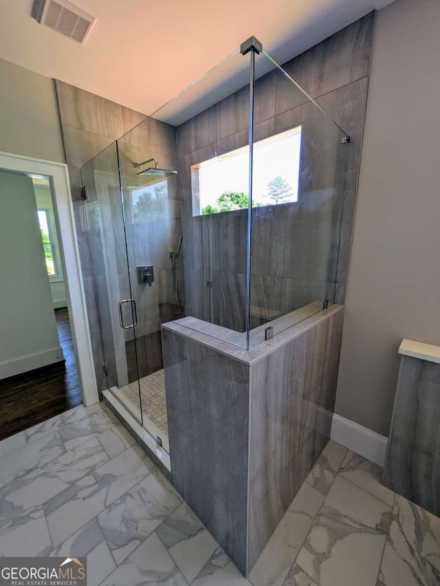 8239 High Lake Ter, Covington, GA 30014 - bathroom with marble look tiles, a stall shower, a freestanding tub, and double vanity