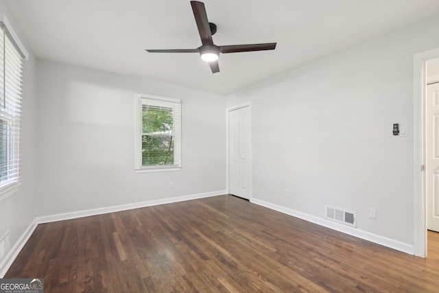 623 Montevista St SW, Atlanta, GA 30310 - spare room featuring dark wood-type flooring, a ceiling fan, and baseboards