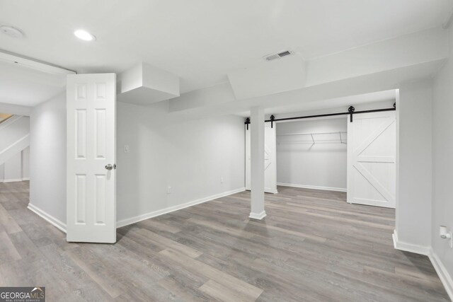 623 Montevista St SW, Atlanta, GA 30310 - finished basement with baseboards, wood finished floors, a barn door, and recessed lighting