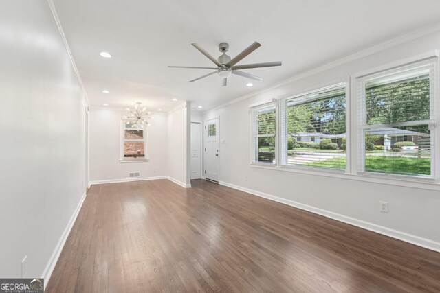 623 Montevista St SW, Atlanta, GA 30310 - unfurnished living room with crown molding, ceiling fan, wood finished floors, baseboards, and a chandelier