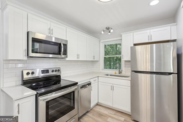 623 Montevista St SW, Atlanta, GA 30310 - kitchen featuring stainless steel appliances, a sink, white cabinetry, light countertops, and recessed lighting
