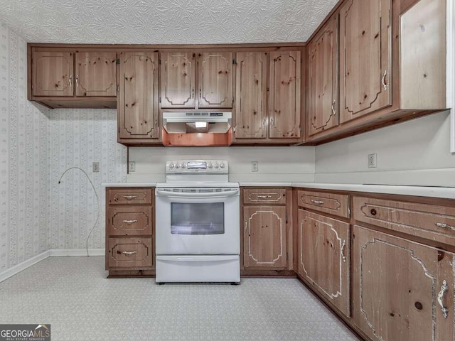 301 Jetta Ln, Canton, GA 30115 - kitchen with electric range, under cabinet range hood, light countertops, wallpapered walls, and baseboards