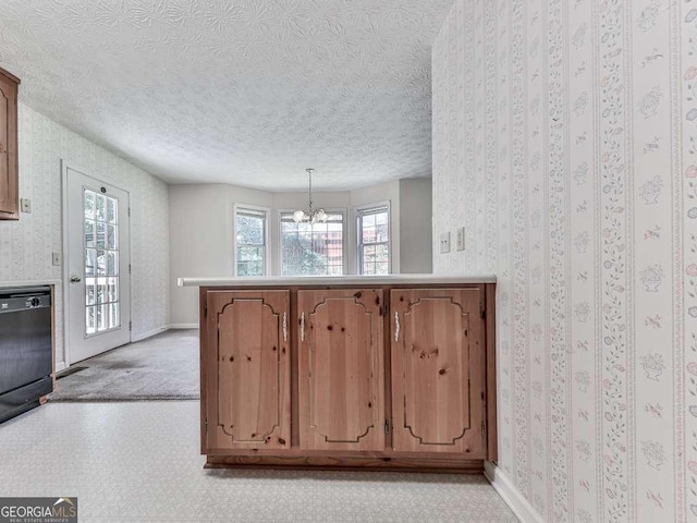 301 Jetta Ln, Canton, GA 30115 - kitchen featuring a chandelier, black dishwasher, a peninsula, baseboards, and a textured ceiling