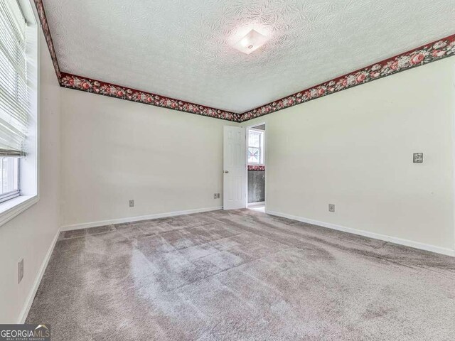 301 Jetta Ln, Canton, GA 30115 - spare room with a textured ceiling, carpet flooring, and baseboards