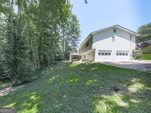 301 Jetta Ln, Canton, GA 30115 - view of side of home featuring an attached garage, driveway, and a lawn