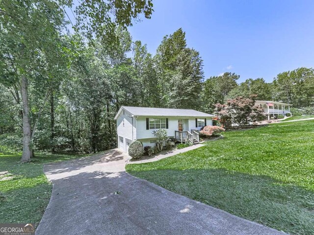 301 Jetta Ln, Canton, GA 30115 - view of front of home featuring concrete driveway, a front lawn, and a garage