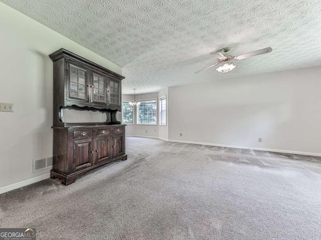 301 Jetta Ln, Canton, GA 30115 - unfurnished living room featuring ceiling fan, baseboards, light colored carpet, a textured ceiling, and a chandelier