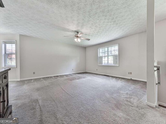 301 Jetta Ln, Canton, GA 30115 - carpeted empty room featuring plenty of natural light, ceiling fan, a textured ceiling, and baseboards