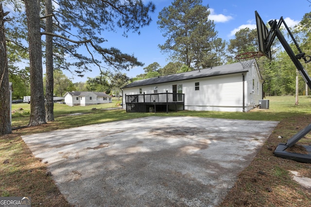 2014 Fence Rd, Dacula, GA 30019 - rear view of house featuring a wooden deck, a lawn, and central AC