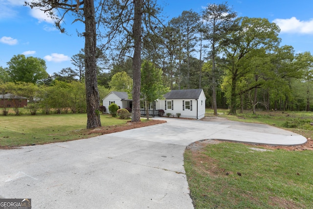 2014 Fence Rd, Dacula, GA 30019 - ranch-style house with concrete driveway, a front yard, and an outbuilding