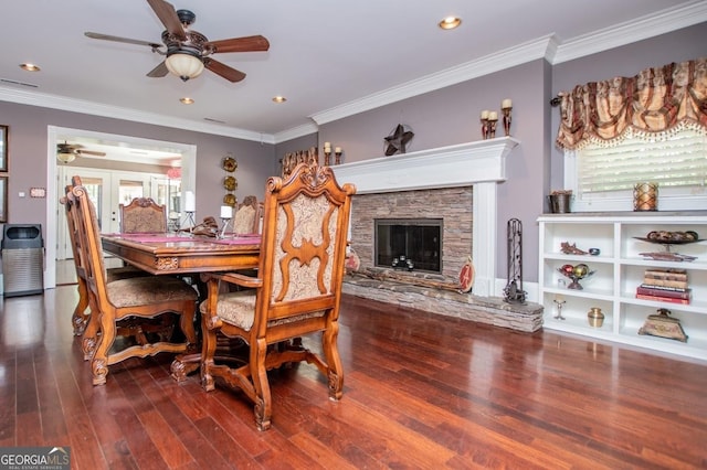 1050 Denton Rd, Douglasville, GA 30134 - dining room featuring ceiling fan, wood finished floors, crown molding, french doors, and a stone fireplace