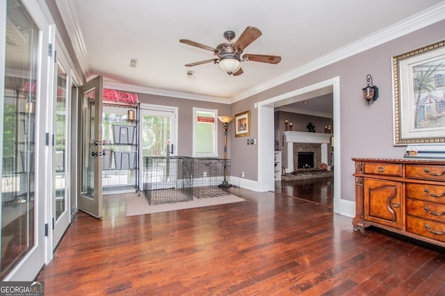 1050 Denton Rd, Douglasville, GA 30134 - living area featuring wood finished floors, ceiling fan, ornamental molding, a fireplace with raised hearth, and baseboards