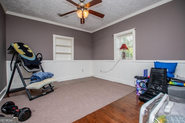 1050 Denton Rd, Douglasville, GA 30134 - workout area with built in features, a wainscoted wall, ceiling fan, a textured ceiling, and wood finished floors