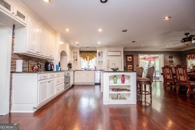 1050 Denton Rd, Douglasville, GA 30134 - kitchen featuring appliances with stainless steel finishes, open shelves, dark countertops, ceiling fan, and ornamental molding