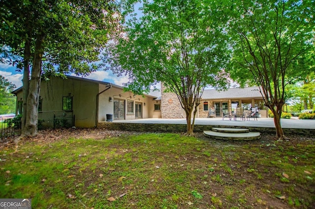 1050 Denton Rd, Douglasville, GA 30134 - rear view of house featuring stucco siding, a patio area, and french doors