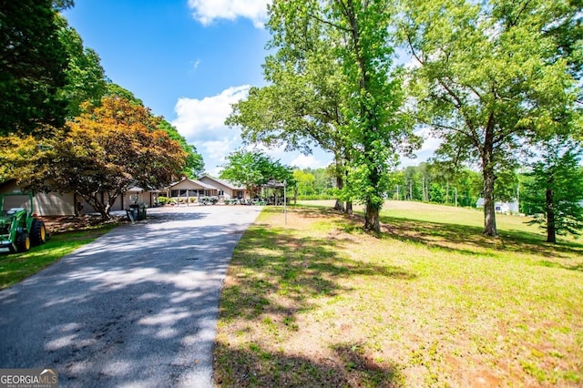 1050 Denton Rd, Douglasville, GA 30134 - view of home's community with a lawn and asphalt driveway