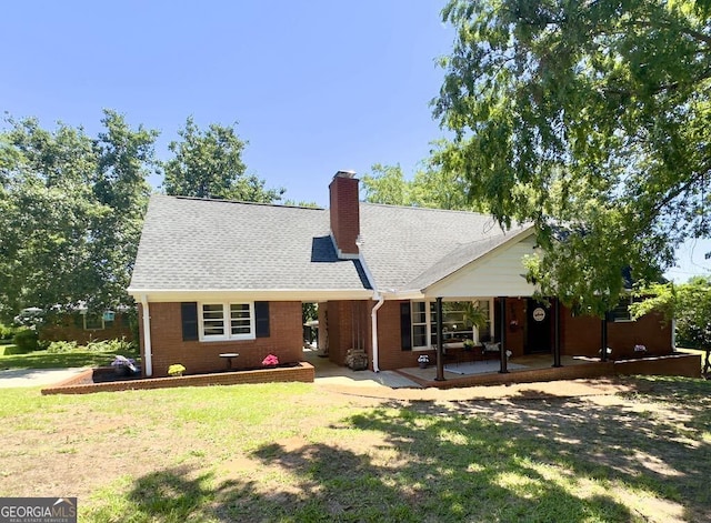 204 Biltmore Ter, Warner Robins, GA 31088 - rear view of property featuring a chimney, a yard, a shingled roof, and brick siding
