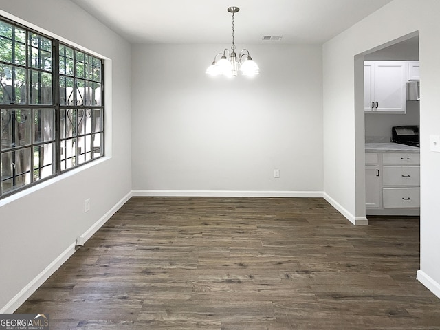 3008 Pine Tree Trl # 16D, South Fulton, GA 30349 - unfurnished dining area featuring a chandelier, baseboards, and dark wood-style floors