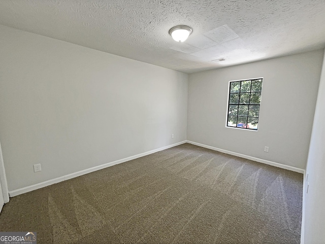 3008 Pine Tree Trl # 16D, South Fulton, GA 30349 - spare room featuring dark carpet, baseboards, and a textured ceiling