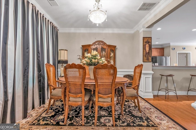 413 Tuxedo Dr, Commerce, GA 30530 - dining room with a chandelier, crown molding, wood finished floors, and recessed lighting