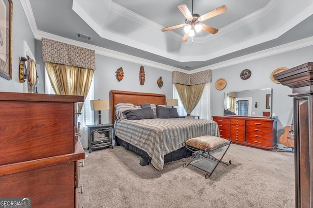 413 Tuxedo Dr, Commerce, GA 30530 - carpeted bedroom featuring a raised ceiling, multiple windows, ornamental molding, and ceiling fan