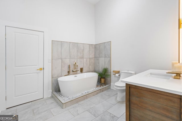 5370 Greenleaf Dr SW, Mableton, GA 30126 - full bathroom featuring a soaking tub, vanity, marble finish flooring, and toilet