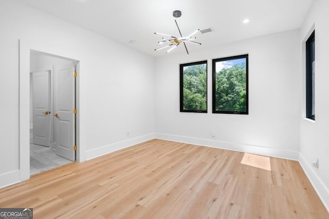 5370 Greenleaf Dr SW, Mableton, GA 30126 - empty room featuring wood finished floors, a chandelier, baseboards, and recessed lighting