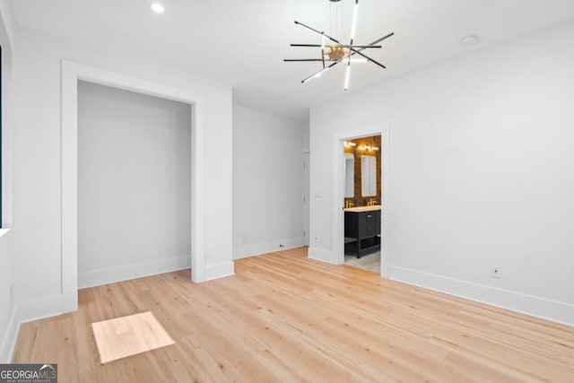 5370 Greenleaf Dr SW, Mableton, GA 30126 - unfurnished bedroom featuring a chandelier, baseboards, light wood-style flooring, ensuite bath, and recessed lighting