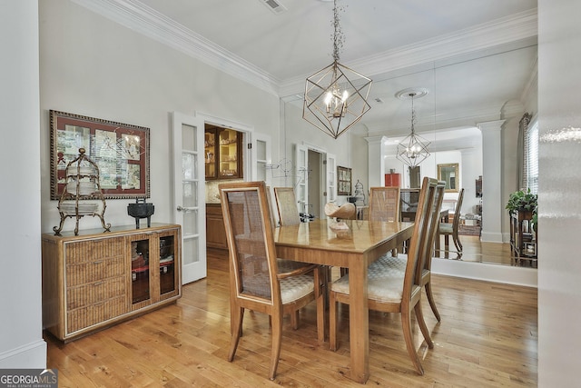 1000 Pleasance Grv, Peachtree City, GA 30269 - dining space with a chandelier, ornamental molding, light wood-style flooring, and decorative columns