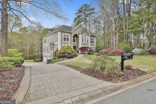 1000 Pleasance Grv, Peachtree City, GA 30269 - view of front of property with an attached garage, driveway, a front lawn, and stucco siding