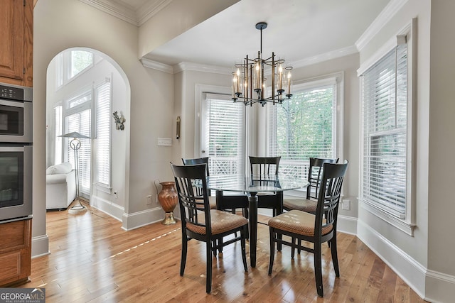 1000 Pleasance Grv, Peachtree City, GA 30269 - dining space featuring a chandelier, light wood-type flooring, baseboards, ornamental molding, and arched walkways