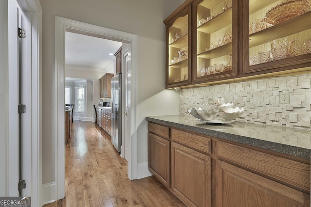 1000 Pleasance Grv, Peachtree City, GA 30269 - bar with ornamental molding, backsplash, stainless steel fridge with ice dispenser, light wood finished floors, and baseboards