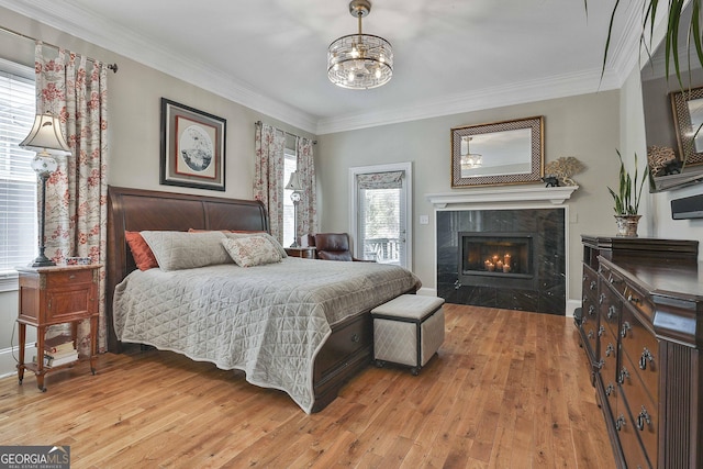 1000 Pleasance Grv, Peachtree City, GA 30269 - bedroom with multiple windows, light wood-type flooring, a premium fireplace, ornamental molding, and baseboards