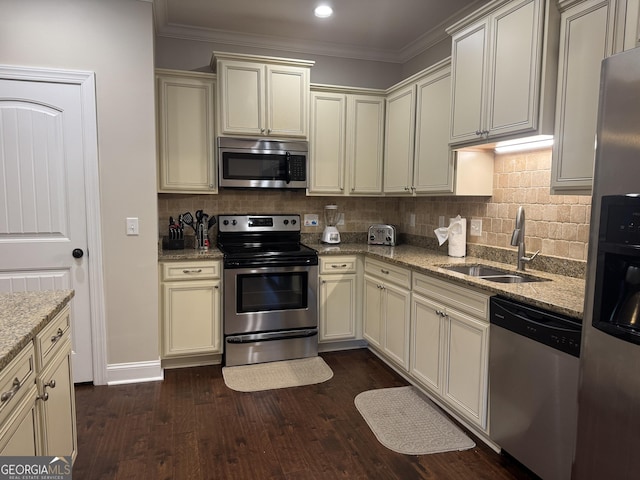306 Reserve Ln, Saint Simons, GA 31522 - kitchen featuring stainless steel appliances, a sink, cream cabinetry, dark wood-style flooring, and ornamental molding